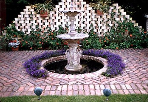 When I designed this patio area, I left a planting strip next to the fountain.  The Lobelia always worked good in this spot.  (This is a very old (circa 2000) low res image)