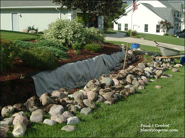 This was an existing wall in disarray.  We dissembled it and are now starting to rebuild.  The wall required over 7 ton of rock and 2 ton of smaller stones for back fill.